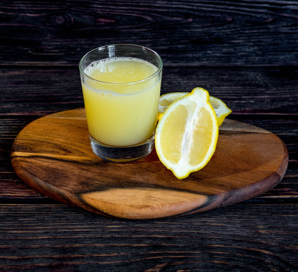 Сок лимона в стакане